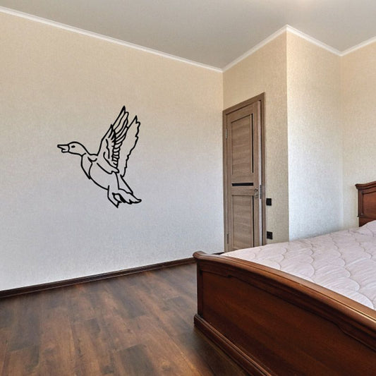 Flying duck decal, black line-art duck in midair on a light wall