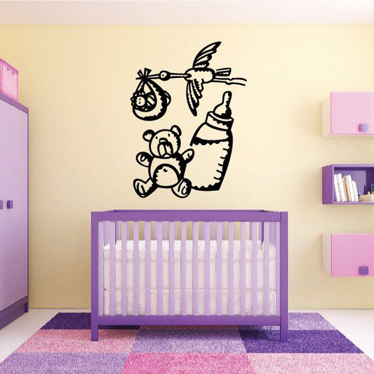 Nursery wall decal of flying stork holding a bottle with bear