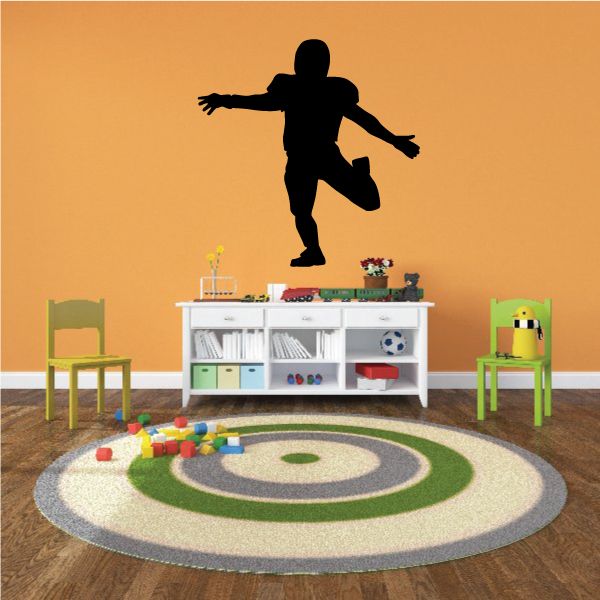 Football player vinyl wall decal, black silhouette kicking action pose