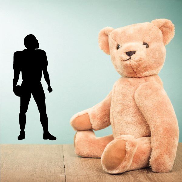 Plush teddy bear with black football player silhouette wall decal