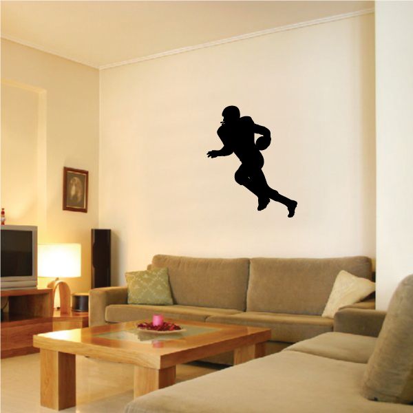 Football player wall decal, black vinyl silhouette of a running athlete