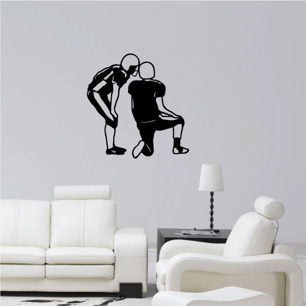 Football wall decal with two football player silhouettes kneeling, black vinyl