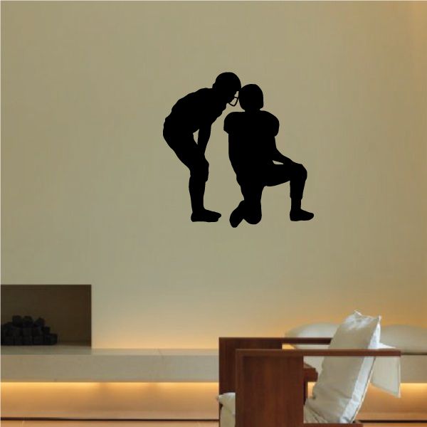 Football player wall decal, black silhouette of two players kneeling