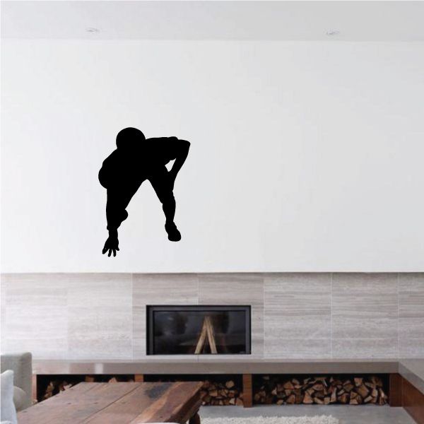 Football player wall decal vinyl, black silhouette of an athlete in mid-play
