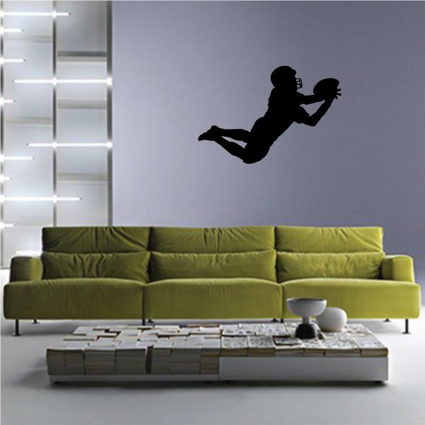 Football wall decal: black player silhouette kicking a ball