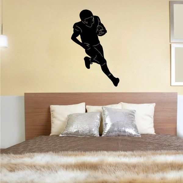 Football player wall decal, black vinyl silhouette on indoor wall