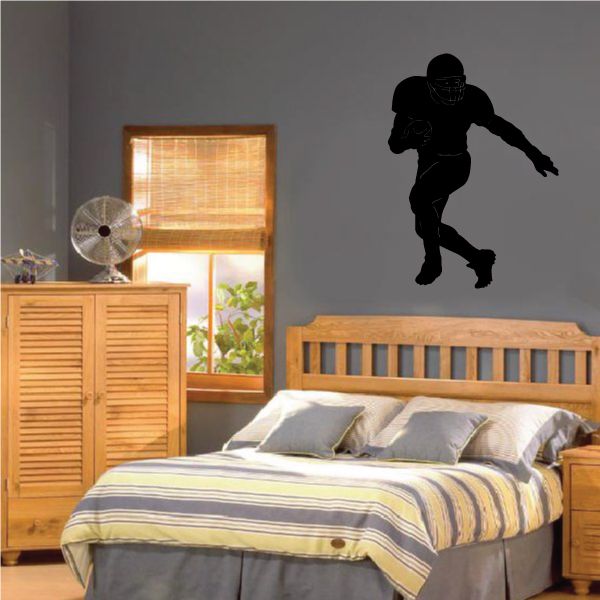 Football wall decal, black vinyl silhouette of a running player