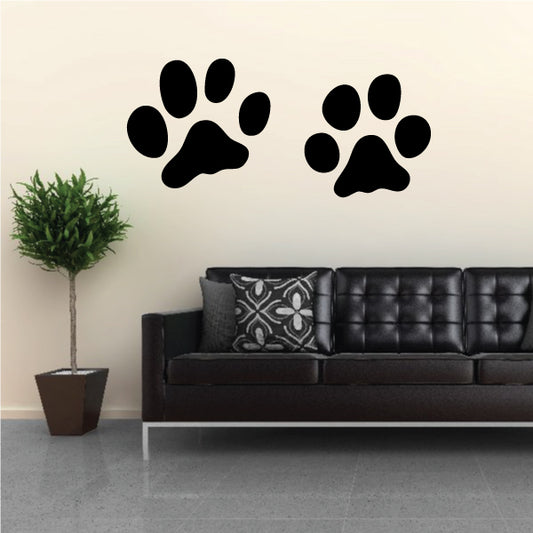 Paw print decals, two large black prints on a wall