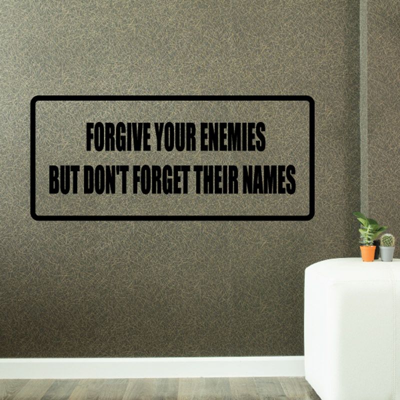 Rectangular wall decal, black border, bold white quote text: FORGIVE ENEMIES, BUT DON'T FORGET NAMES