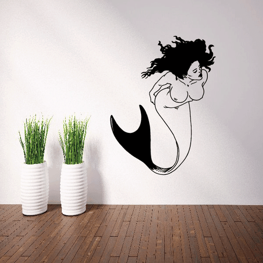 Black mermaid swimming decal with curled forked tail and stylized hair
