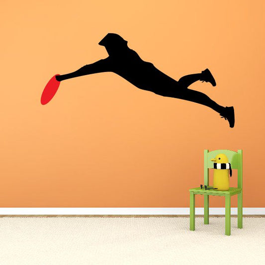 Frisbee player lunging wall decal, black silhouette with red flying disc