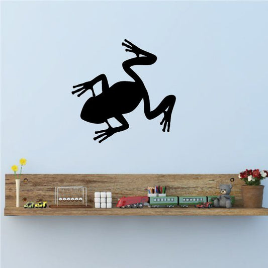 Black frog silhouette wall decal, hopping pose with open mouth and long legs.