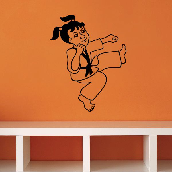 Karate wall decal of a girl in black punching and kicking pose