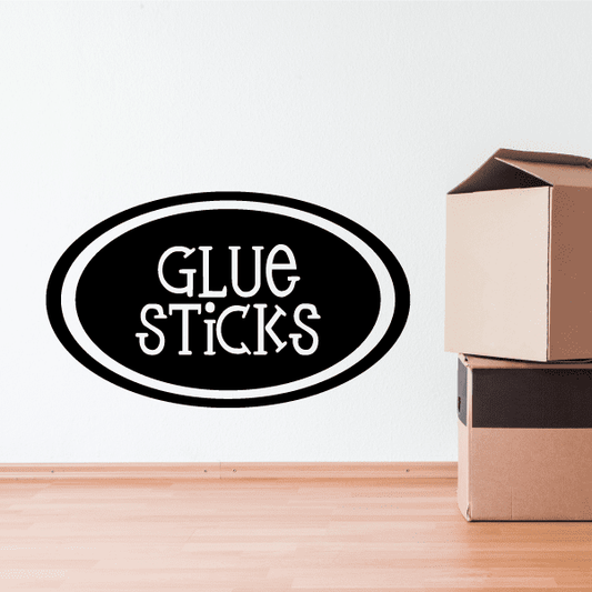 Black oval decal with white text “Glue Sticks”