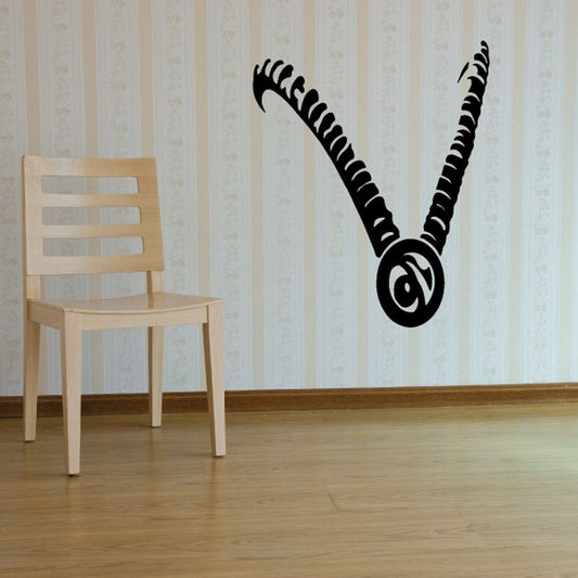 Goat horns and eye wall decal, black outlined curly horns with central swirl eye