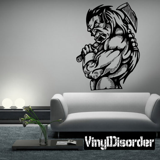 Image of a detailed Vinyl wall art of an orc holding a battle axe and Orc Decals