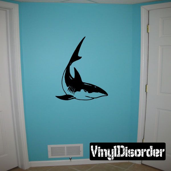 Wall decal of a black turning shark with curled tail and fin details