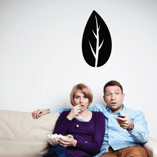 Graphic leaf decal showing a black leaf emblem centered above a sofa.
