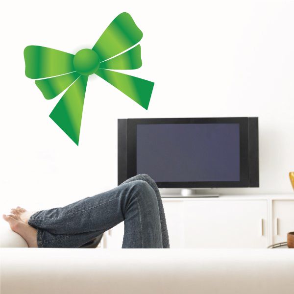 Green ribbon bow sticker with layered loops and curled tails
