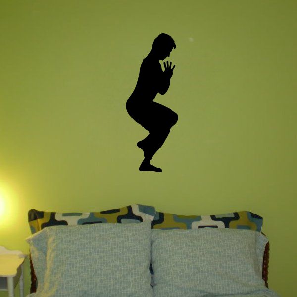 Gymnastics wall decal: black gymnast silhouette crouching with hands raised