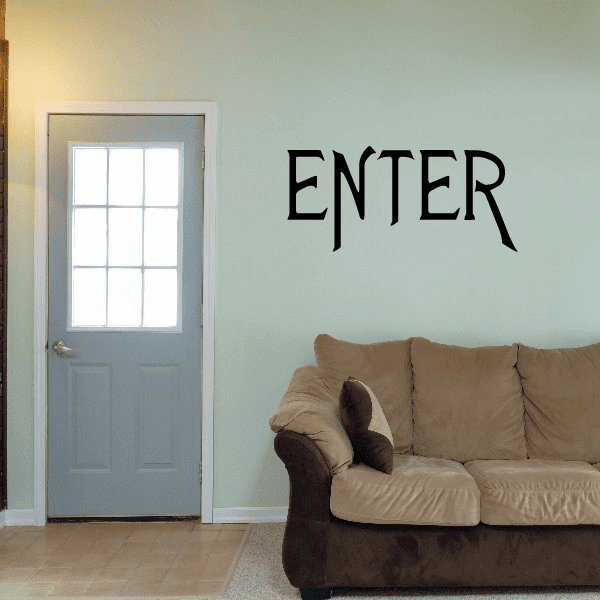 Decorative wall decal with black “ENTER” lettering above a sofa