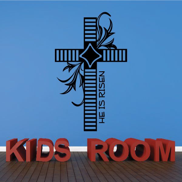Wall decal featuring a cross with ruler lines, angel silhouette, and 'He Is Risen' text.