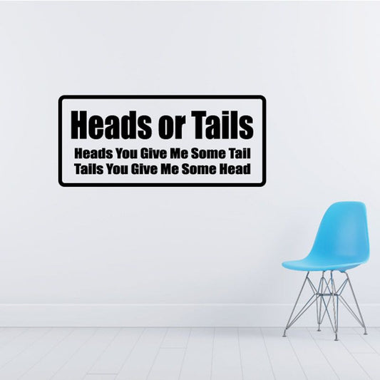 Wall decal: 'Heads or Tails' quote in black text on white rectangle