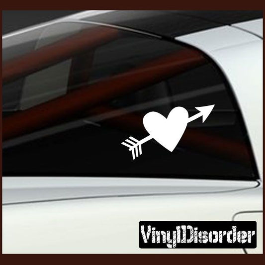 White heart decal pierced by arrow on car window, with small arrow detail.
