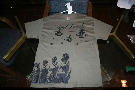 Green graphic T-shirt with gasmask-style figures