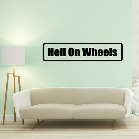 Wall decal with bold black border and white text reading 'Hell On Wheels'.