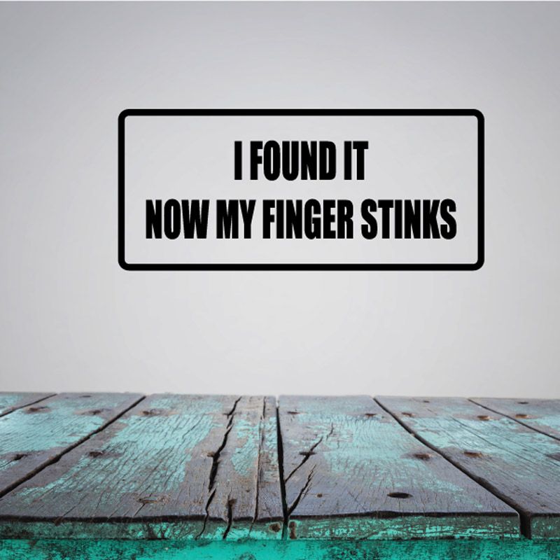 Black rectangular wall decal with text: 'I FOUND IT NOW MY FINGER STINKS'.