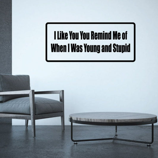 Rectangular wall decal with black outline and bold message text on light background