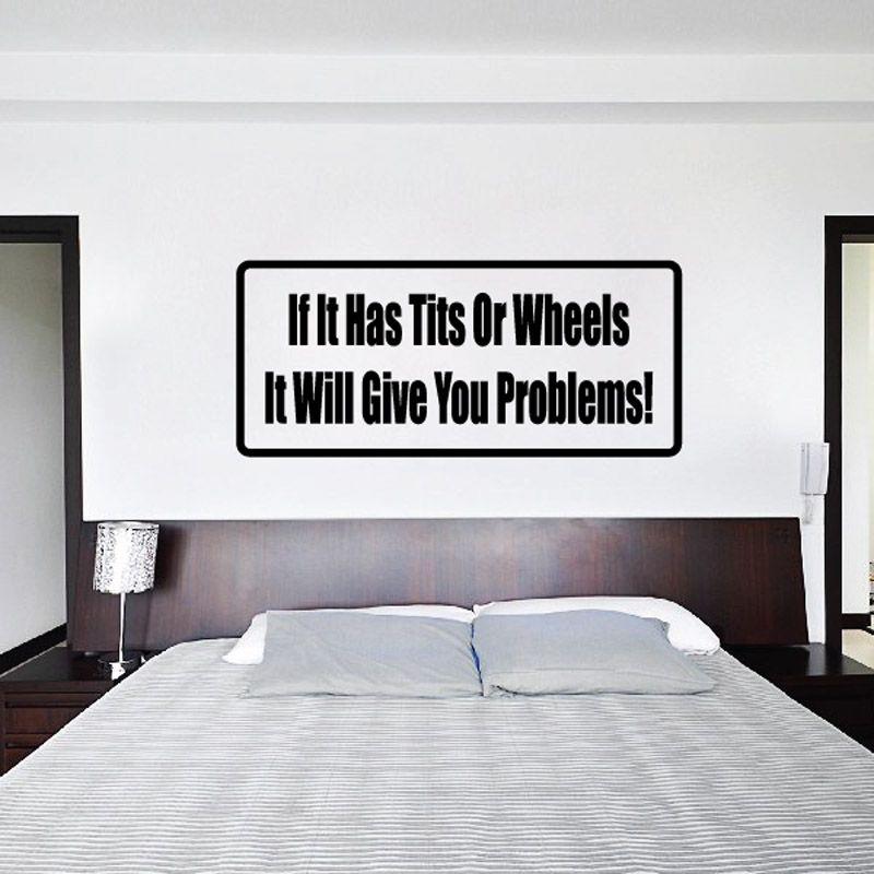 Rectangular wall decal with black border and text: 'If It Has Tits Or Wheels, It Gives Problems!'