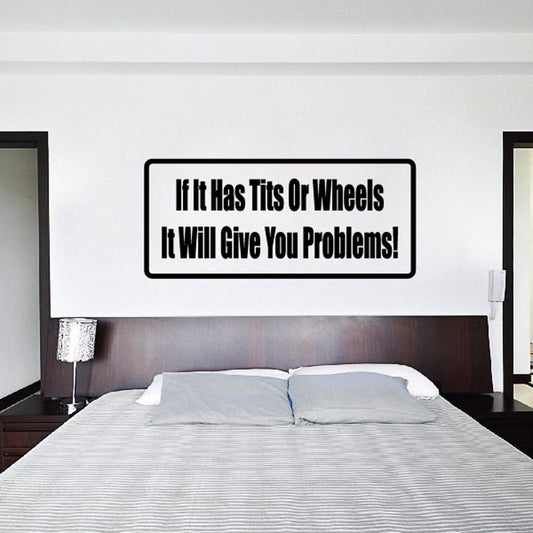 Rectangular wall decal with black border and text: 'If It Has Tits Or Wheels, It Gives Problems!'
