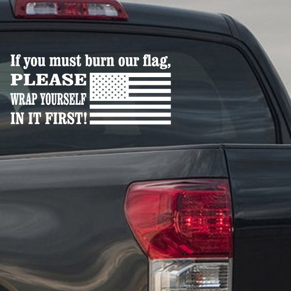 American flag decal with stars, stripes, and quote text on car window.