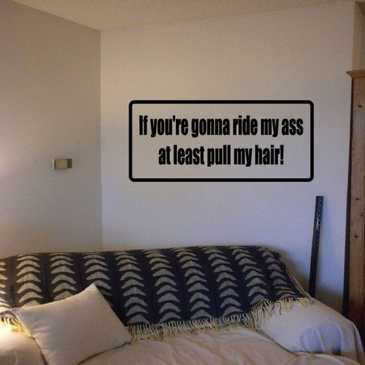 Rectangular wall decal with black quote text and thick border: “If you’re gonna ride my ass…”