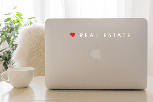 Horizontal 9-inch I heart real estate decal for laptop, white text on light background