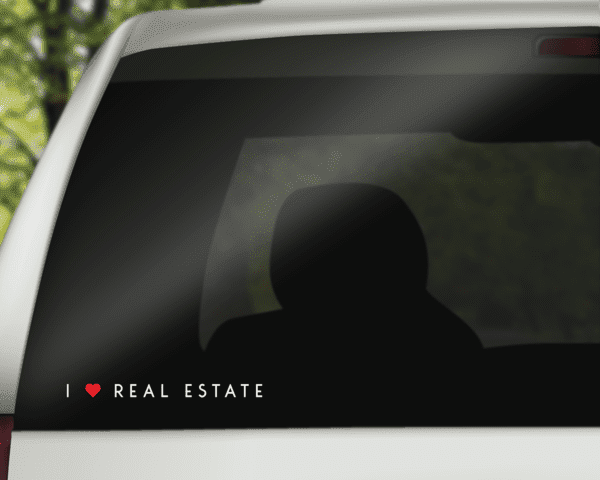 Horizontal 9-inch real estate decal on car window, white 'I heart REAL ESTATE' lettering