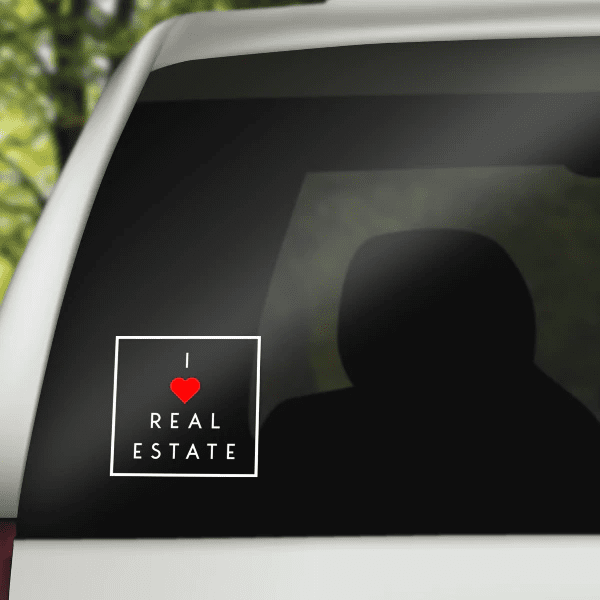 Square decal: red heart and 'REAL ESTATE' on dark background