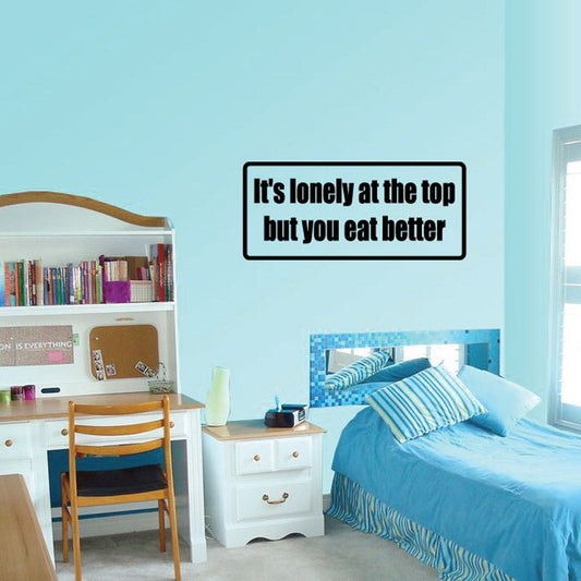 Black-bordered wall decal with text: "It's lonely at the top but you eat better"