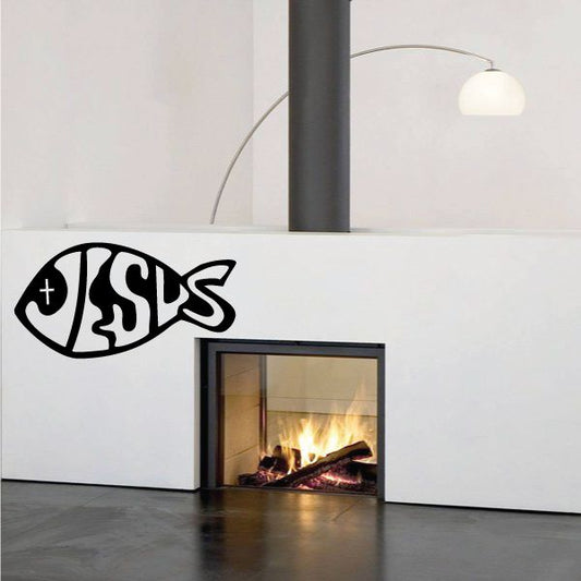 Black fish-shaped Jesus text decal with stylized letters on white surface