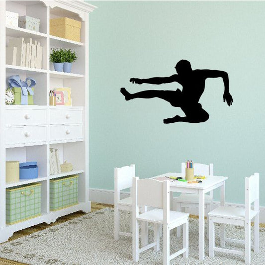 Karate wall decal of black martial artist silhouette mid-kick