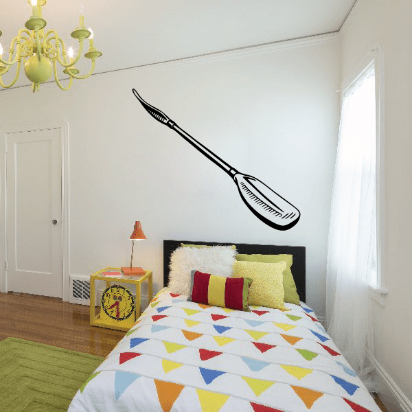 Kayak wall decal featuring a black paddle and kayak silhouette on a wall