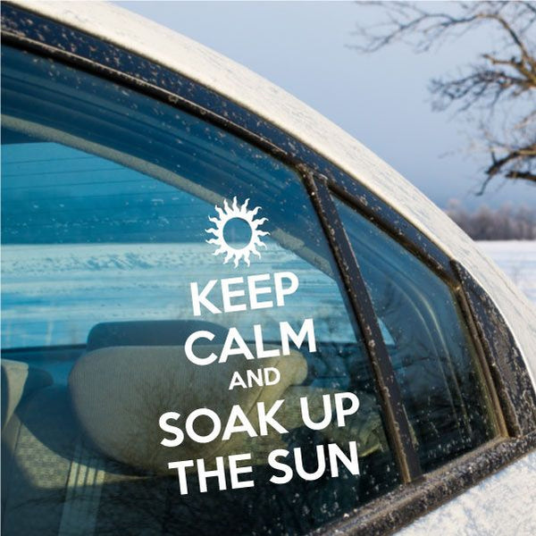 Sun-themed window decal with a white sun icon and text: "KEEP CALM AND SOAK UP THE SUN"