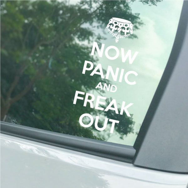 Car window decal with white text "NOW PANIC AND FREAK OUT"
