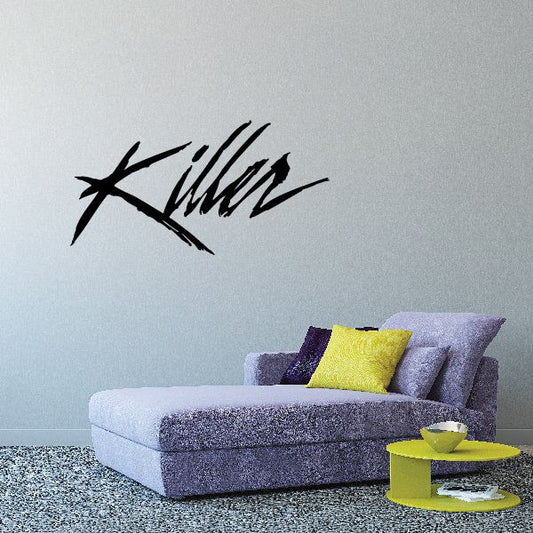 Black stylized decal lettering on a light wall
