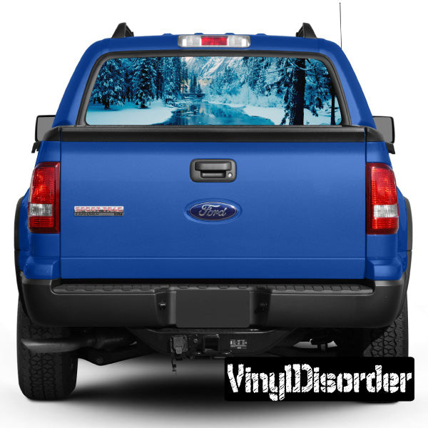 Blue pickup truck rear window with landscape graphic