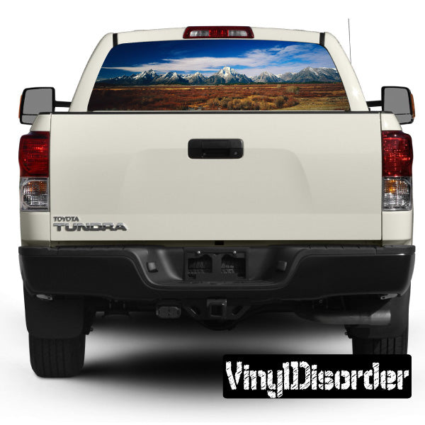 Truck rear window landscape graphic decal with mountain scene, view-through style