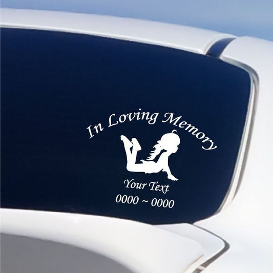 Memorial decal with white cherub holding heart on dark blue surface