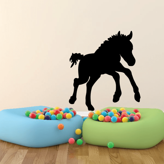 Leaping foal decal with black silhouette, rearing horse mid-jump